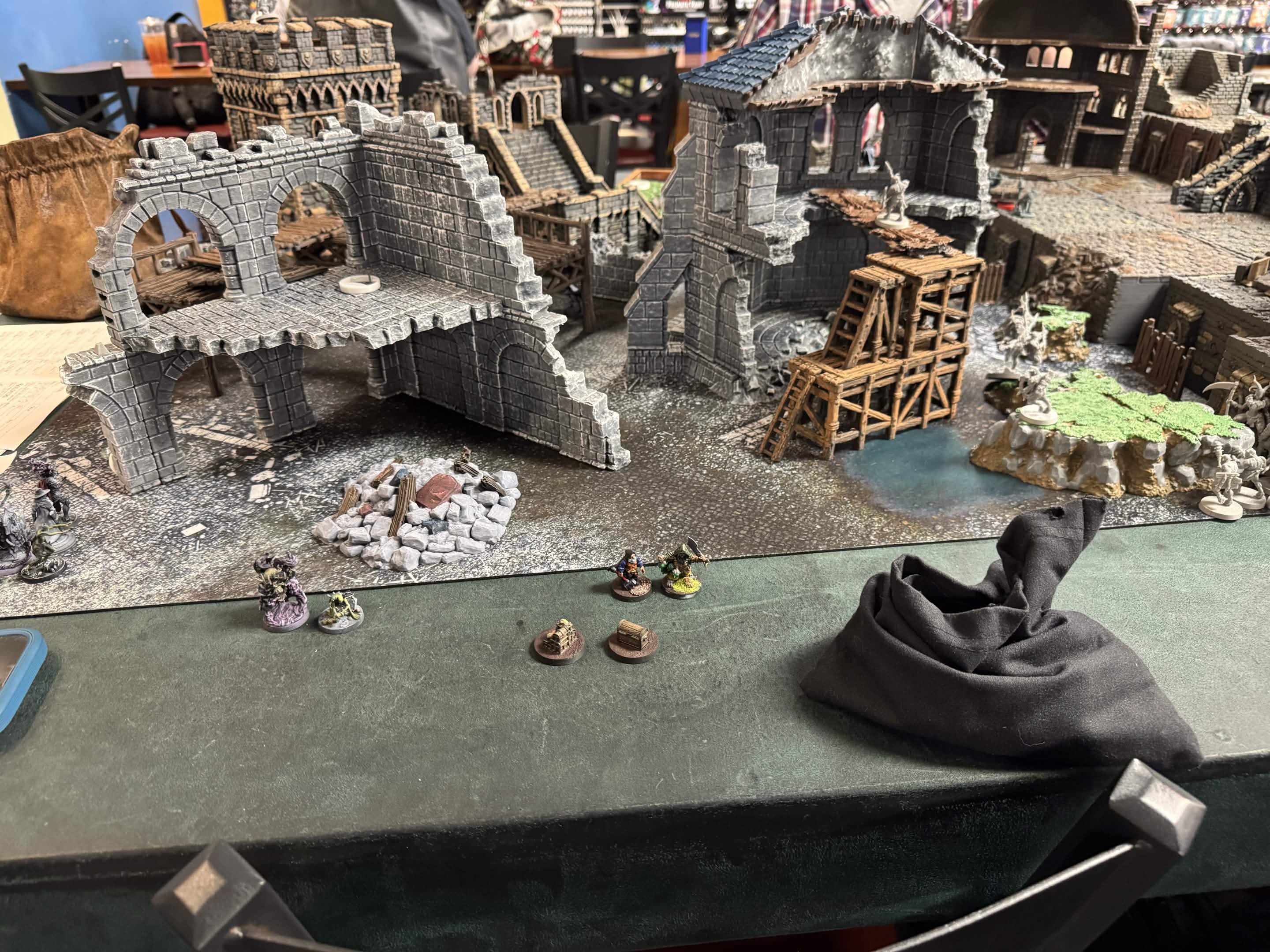 Frostgrave miniatures on a snow-covered ruins table.