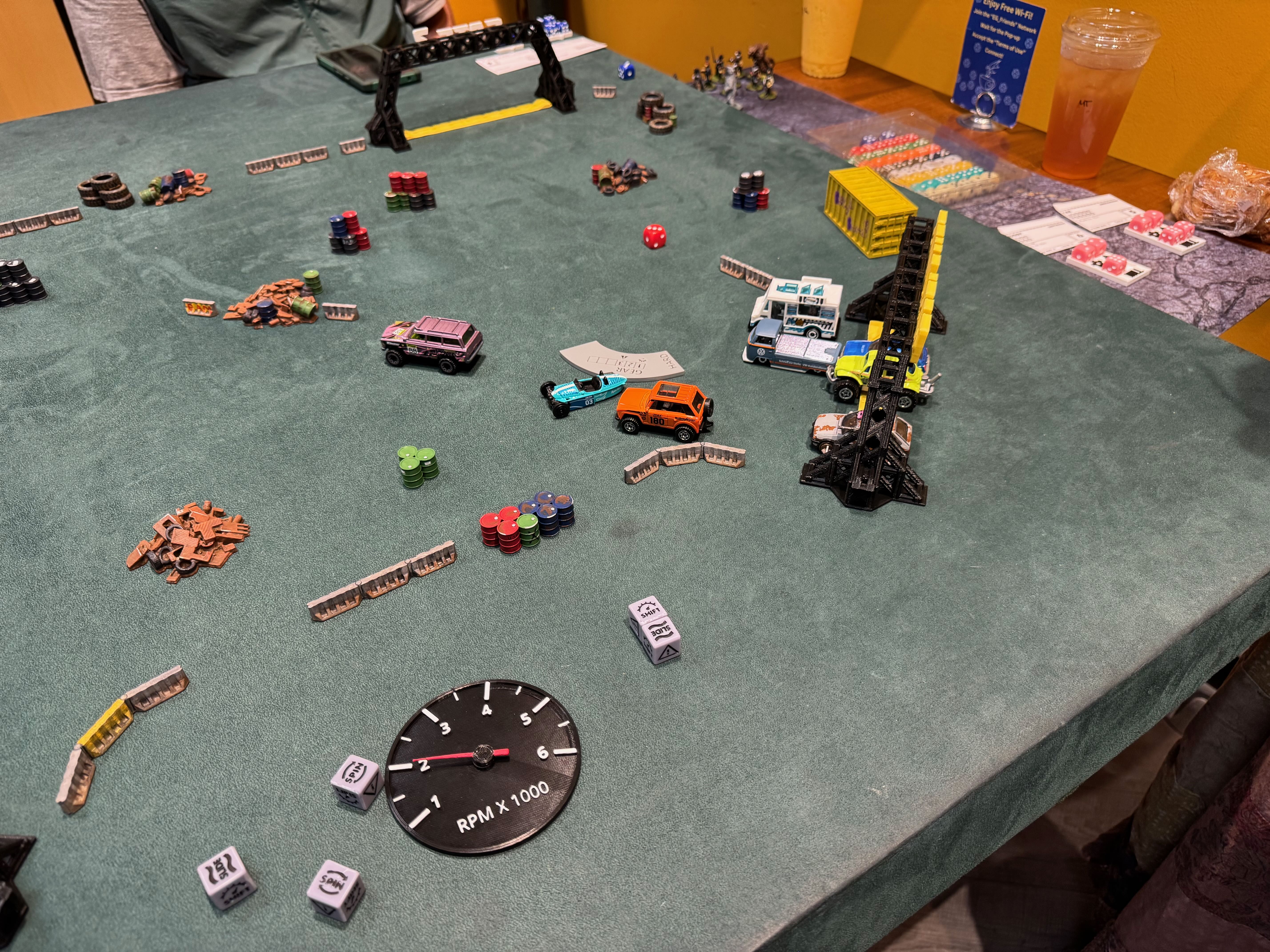 Converted toy cars race around a Gaslands course, weapons blazing.