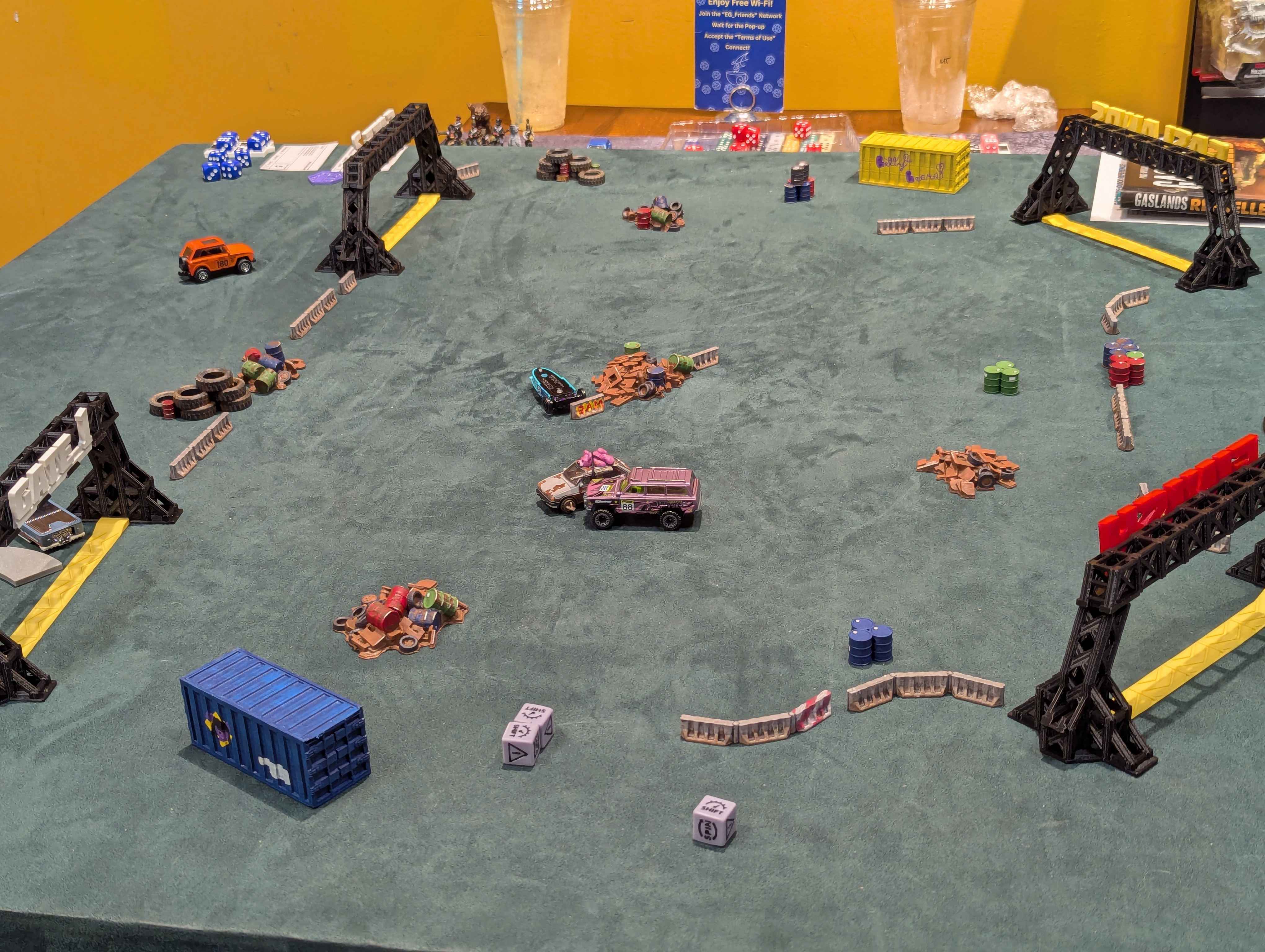 Cars collide and skid across the table during a Gaslands race.